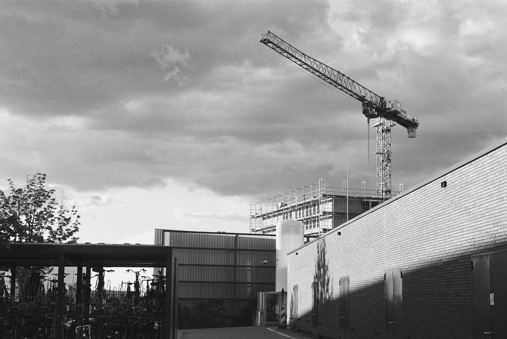 A construction crane against some dramatic clouds. Shot in Ilford Delta 400