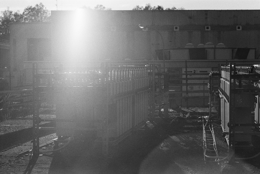 Large banks of condensators with a strong sunflare in the image. Shot in Ilford Delta 400