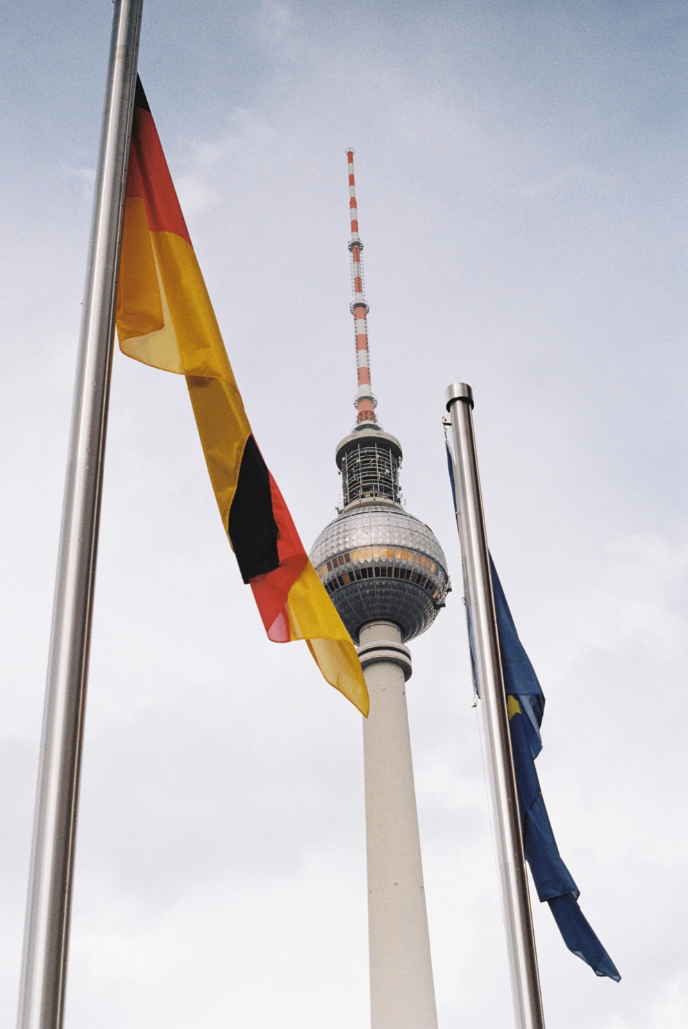 The Berlin TV tower with the flags of Germany and the European Union in the foreground. Shot on Kodak ColorPlus 200.